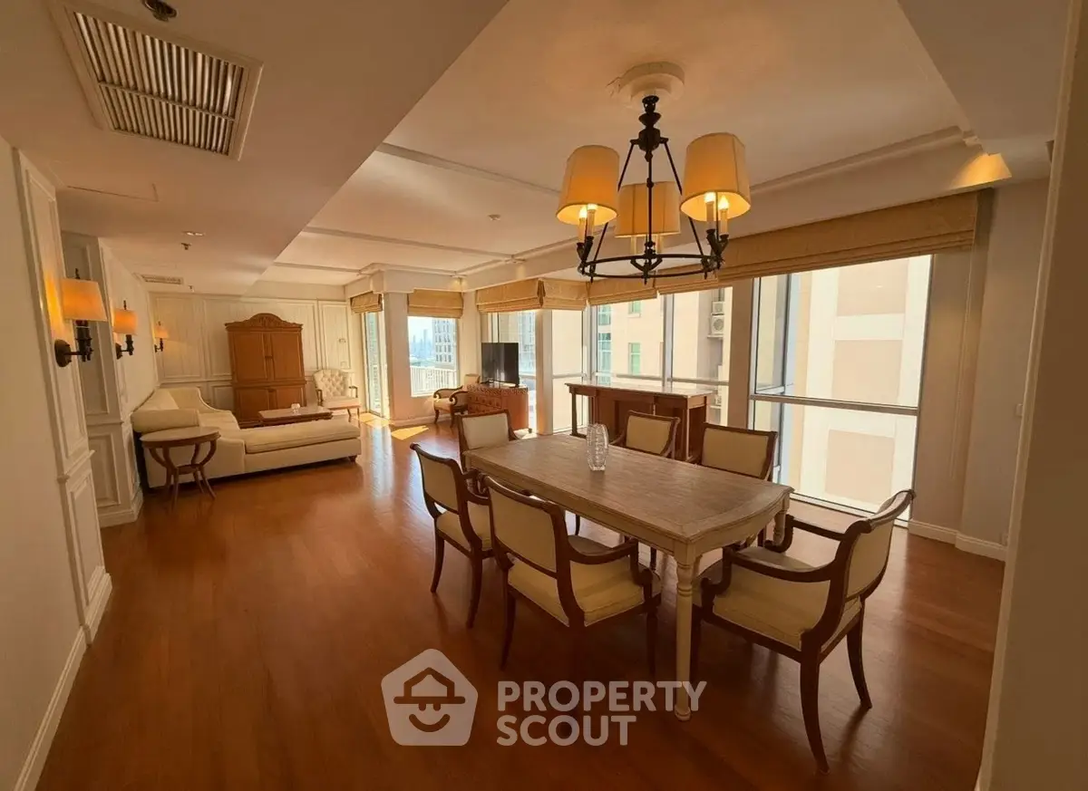 Spacious dining and living area with elegant wooden flooring and classic furniture in a luxury apartment.