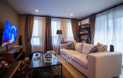 Modern living room with cozy sofa, stylish decor, and large windows for natural light.