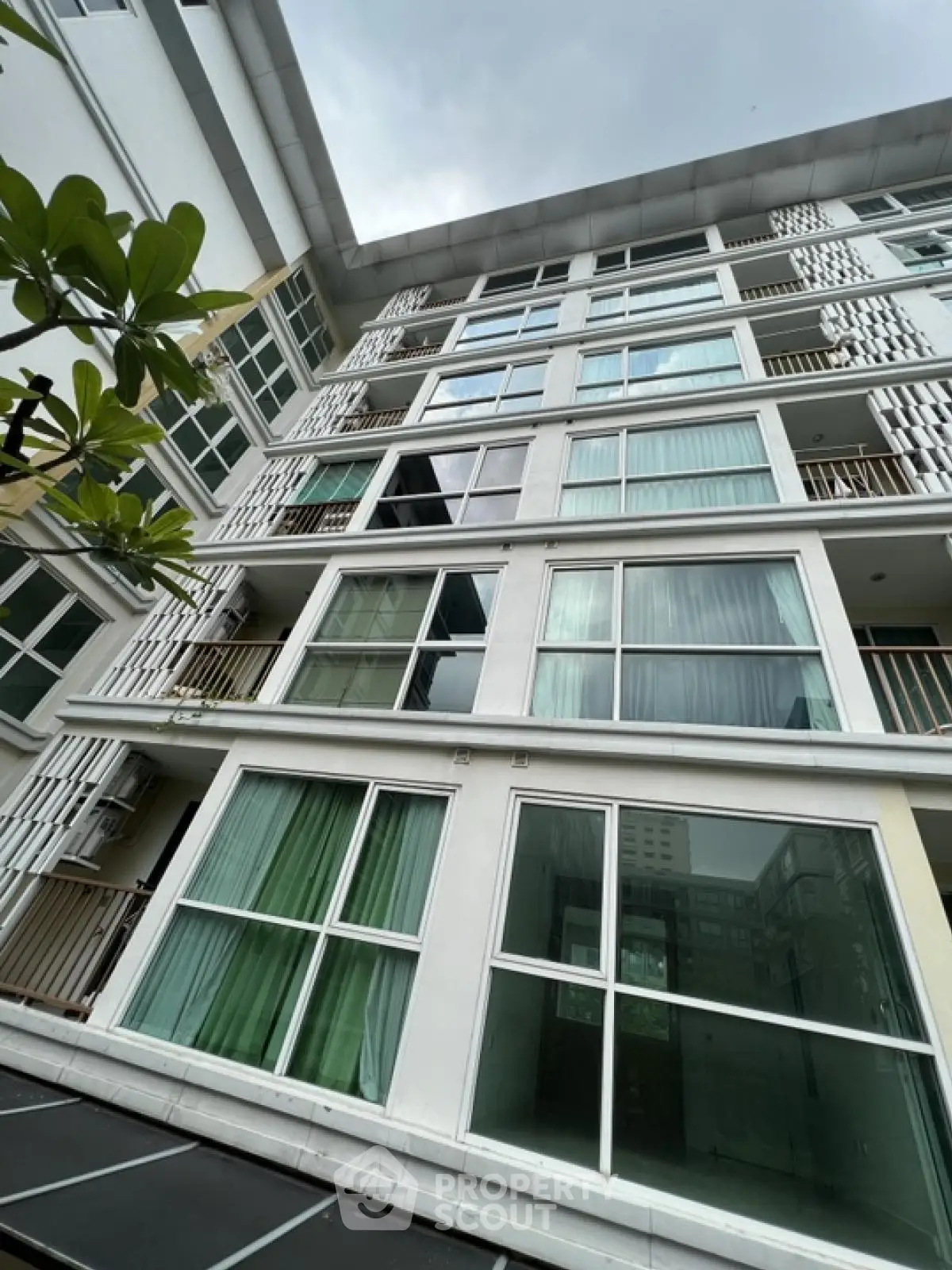 Modern apartment building exterior with large windows and balconies