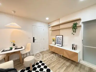 Modern living room with stylish decor and dining area, featuring wooden flooring and contemporary furniture.