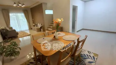Spacious dining area with modern decor and natural light in a stylish home.