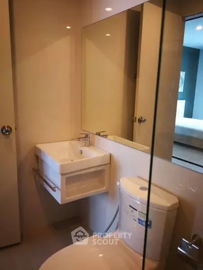 Modern bathroom with sleek fixtures and minimalist design in a contemporary apartment.