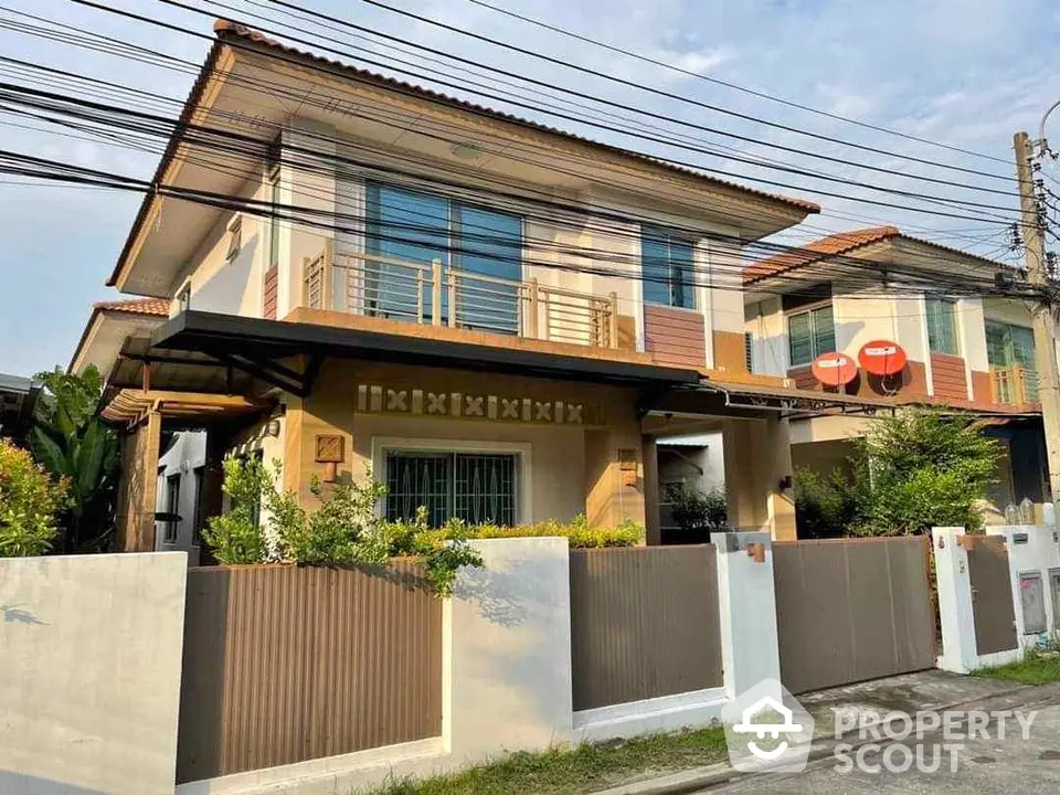 Charming two-story house with modern design and lush garden in a serene neighborhood.