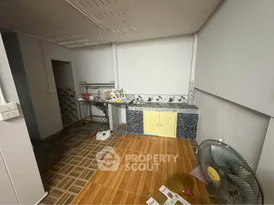 Spacious kitchen with tiled floor and modern sink area