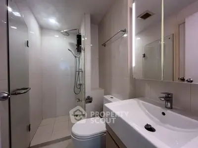 Modern bathroom with sleek fixtures and spacious shower area.