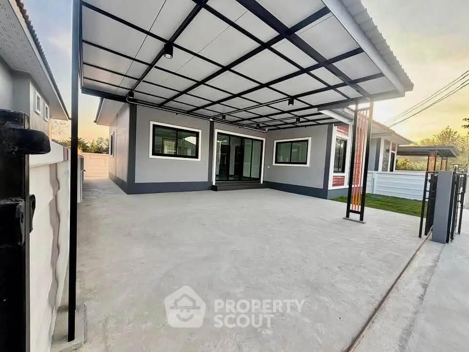 Modern single-story home with spacious driveway and sleek exterior design.
