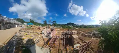 Panoramic view of a construction site with clear blue skies and scenic surroundings.