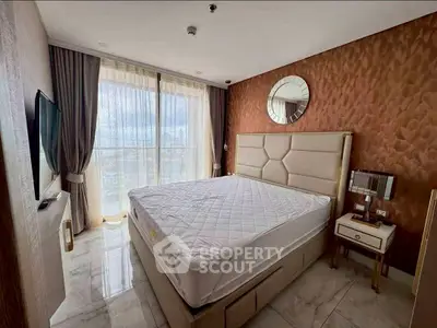 Luxurious bedroom with modern decor and large window offering natural light.