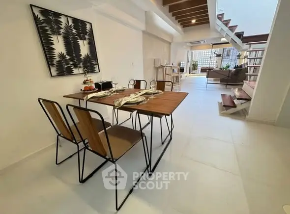 Modern open-plan living and dining area with stylish decor and ample natural light.