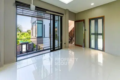 Spacious modern living room with large windows and balcony access