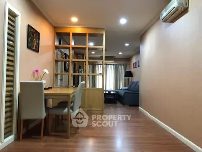 Spacious open-plan living room with modern decor and wooden flooring