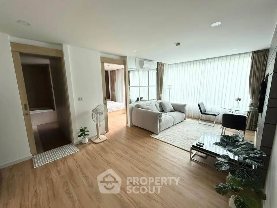 Spacious modern living room with large windows and elegant decor