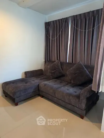 Cozy living room with plush sectional sofa and elegant curtains