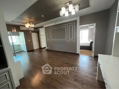 Spacious modern living room with elegant lighting and wooden flooring