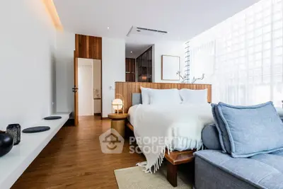Luxurious modern bedroom with wooden flooring and stylish decor