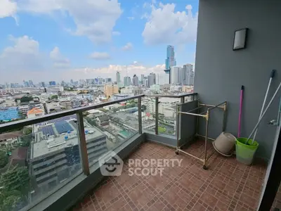 Spacious balcony with stunning city skyline view in modern high-rise apartment.