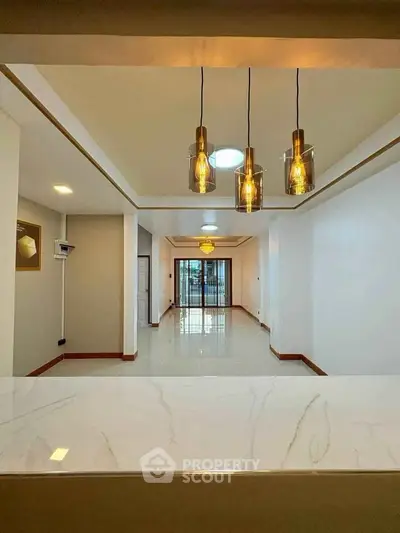 Spacious modern living room with elegant lighting and marble countertop