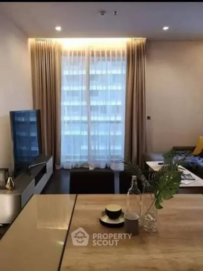 Modern living room with elegant decor and large window, perfect for urban living.