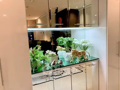 Luxurious interior with elegant decor and mirrored cabinets in a modern living space.