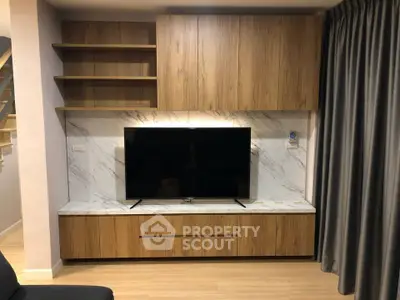 Modern living room with sleek wooden TV cabinet and marble accents
