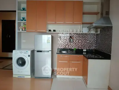 Modern kitchen with washing machine and fridge in compact layout
