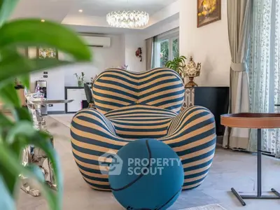Luxurious living room with unique striped armchair and elegant decor
