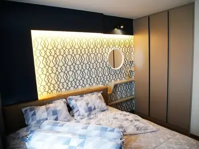 Modern bedroom with stylish geometric wallpaper and cozy lighting