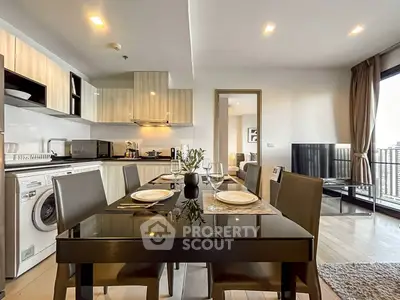 Modern open-layout kitchen and dining area with sleek furniture and appliances