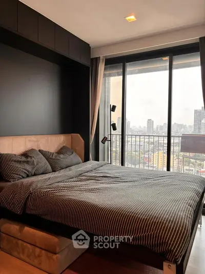 Modern bedroom with city view and floor-to-ceiling windows in luxury apartment