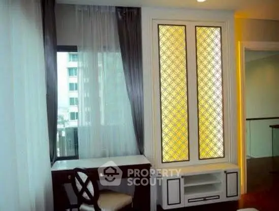 Elegant study area with stylish window design and classic furniture