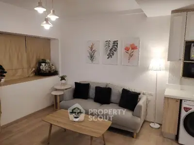Charming living room with modern decor, cozy sofa, and stylish lighting in a contemporary apartment.