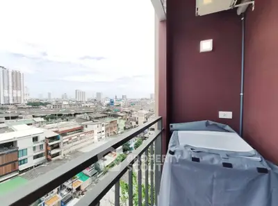 Stunning city view from modern apartment balcony with laundry area.