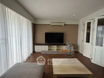 Spacious living room with modern decor and large windows for natural light.