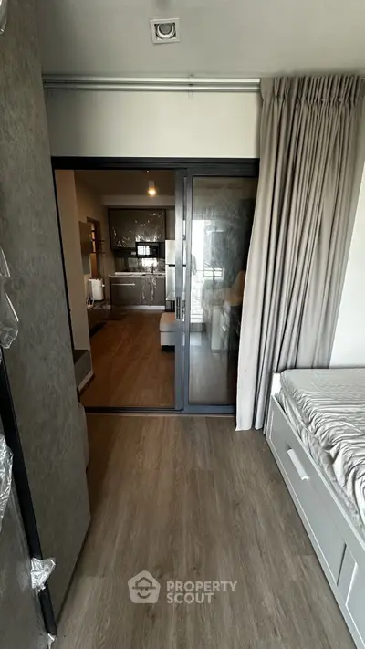 Modern apartment interior with sliding glass doors and stylish kitchen
