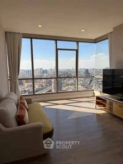 Spacious living room with panoramic city view and modern furnishings