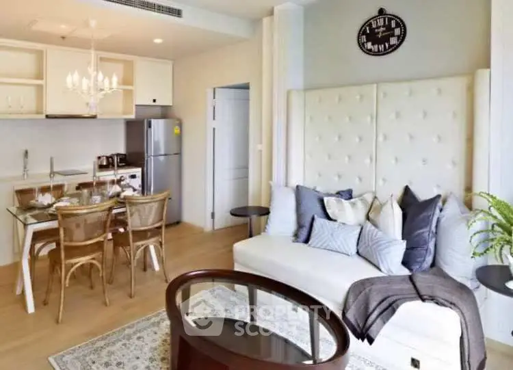 Chic modern living room with open kitchen, elegant decor, and cozy seating area in a stylish apartment.