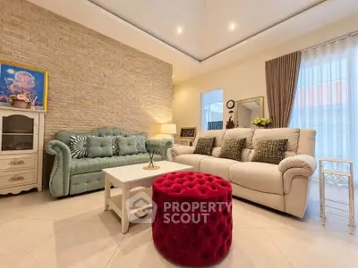 Elegant living room with plush sofas, stylish decor, and natural light, perfect for relaxation and entertaining.
