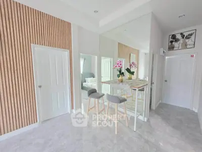 Modern interior with stylish bar stools and decorative wall panels in a bright living space.