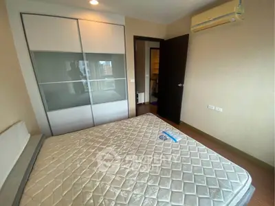 Spacious bedroom with modern sliding wardrobe and air conditioning