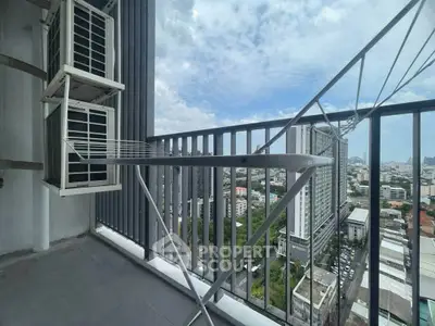 High-rise balcony with city view and air conditioning units, perfect for urban living.