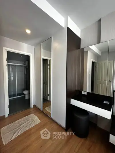 Modern bedroom with ensuite bathroom and sleek vanity area
