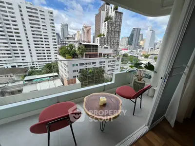 Stunning city view from modern balcony with stylish seating and table