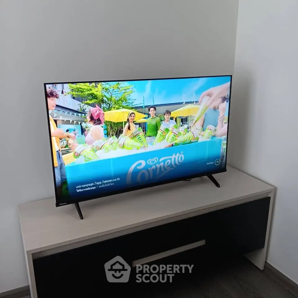 Modern living room with sleek TV on stylish console, perfect for entertainment.