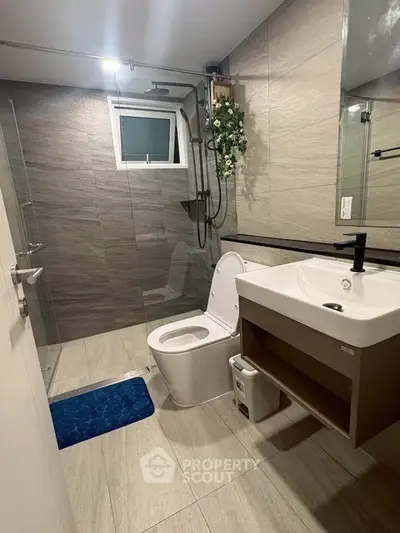 Modern bathroom with sleek fixtures and glass shower enclosure