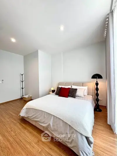 Spacious modern bedroom with elegant decor and natural light