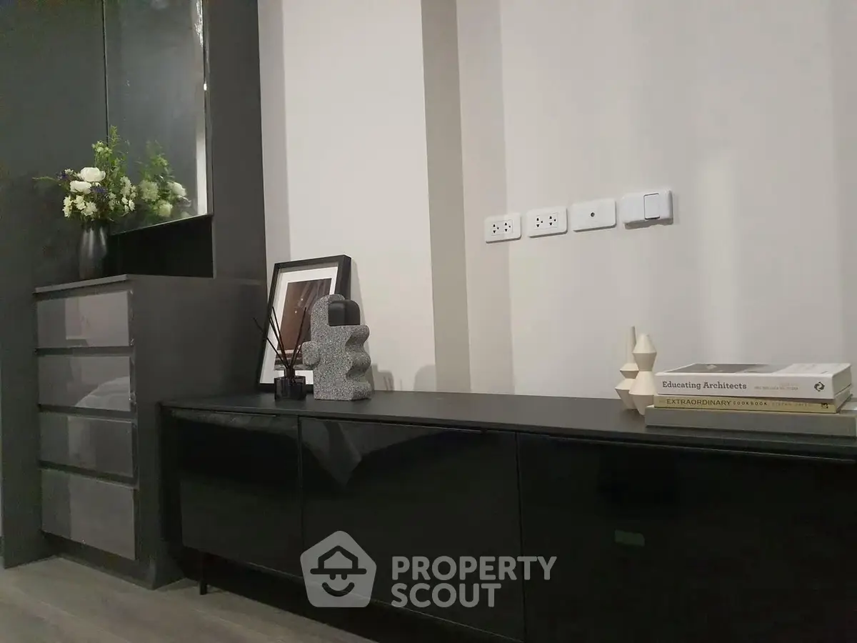 Modern interior with sleek black furniture and decorative elements, perfect for stylish living.