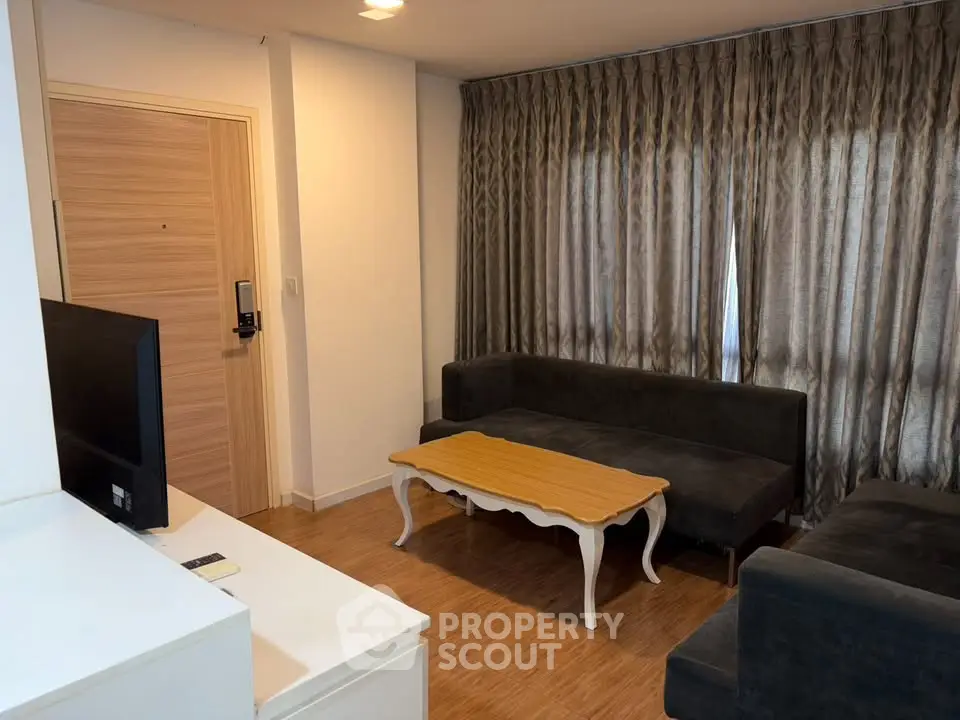 Cozy living room with elegant curtains and stylish furniture in modern apartment.