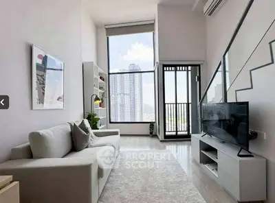 Modern living room with high ceilings and large windows offering city views.