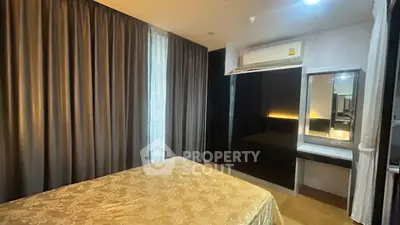 Cozy bedroom with elegant curtains and modern furnishings in a stylish apartment.
