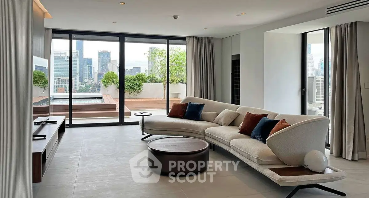 Luxurious living room with modern furniture and stunning city view from large windows.